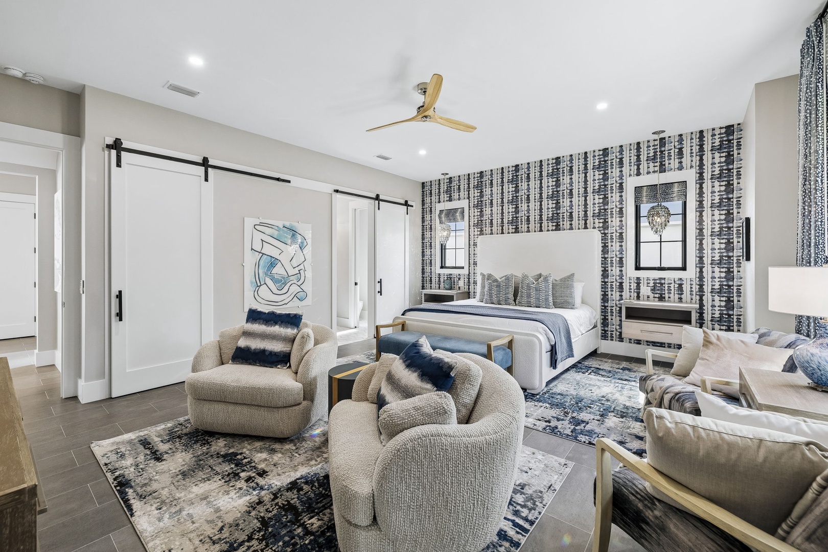 Your spacious primary suite blends comfort with modern elegance. Sink into plush seating, unwind on the crisp king bed, and enjoy the calming coastal-inspired palette that makes every morning and evening feel like a serene retreat.
