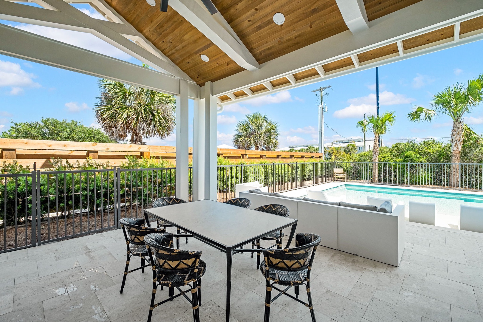 Dine poolside under a vaulted wood ceiling as warm sunlight and tropical breezes surround your private outdoor retreat.