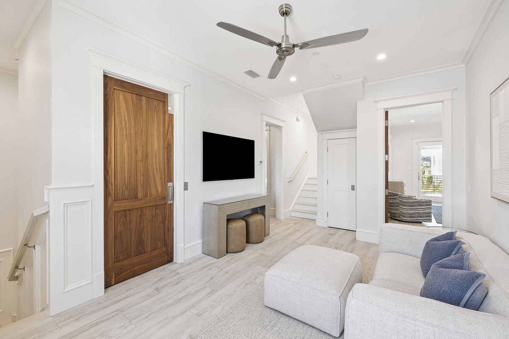 Unwind in your bright, airy living space with plush seating, modern entertainment, and coastal-inspired design details that create the perfect retreat.