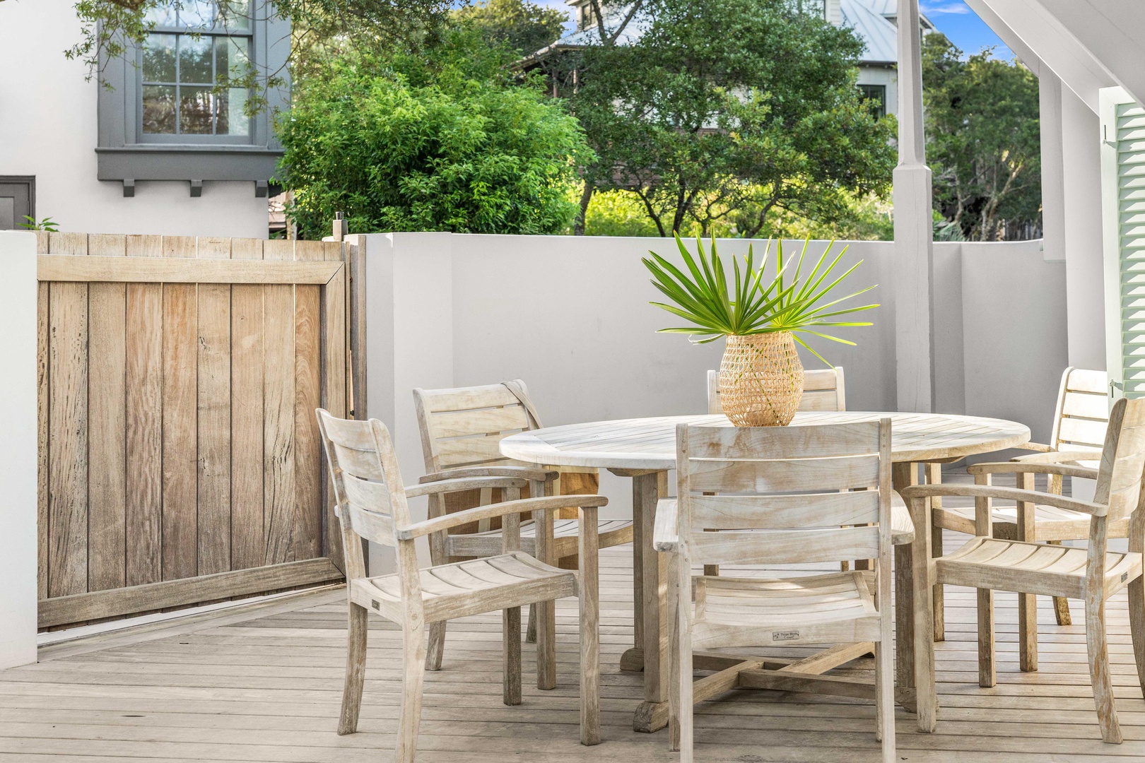 Savor morning coffee or evening meals at your private outdoor dining space, complete with weathered teak furniture and tropical palm accents.
