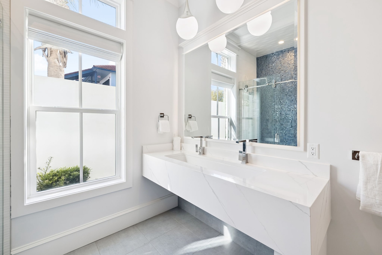 Step into your spa-like sanctuary with marble counters, elegant fixtures, and a stunning tiled shower that makes every morning feel luxurious.