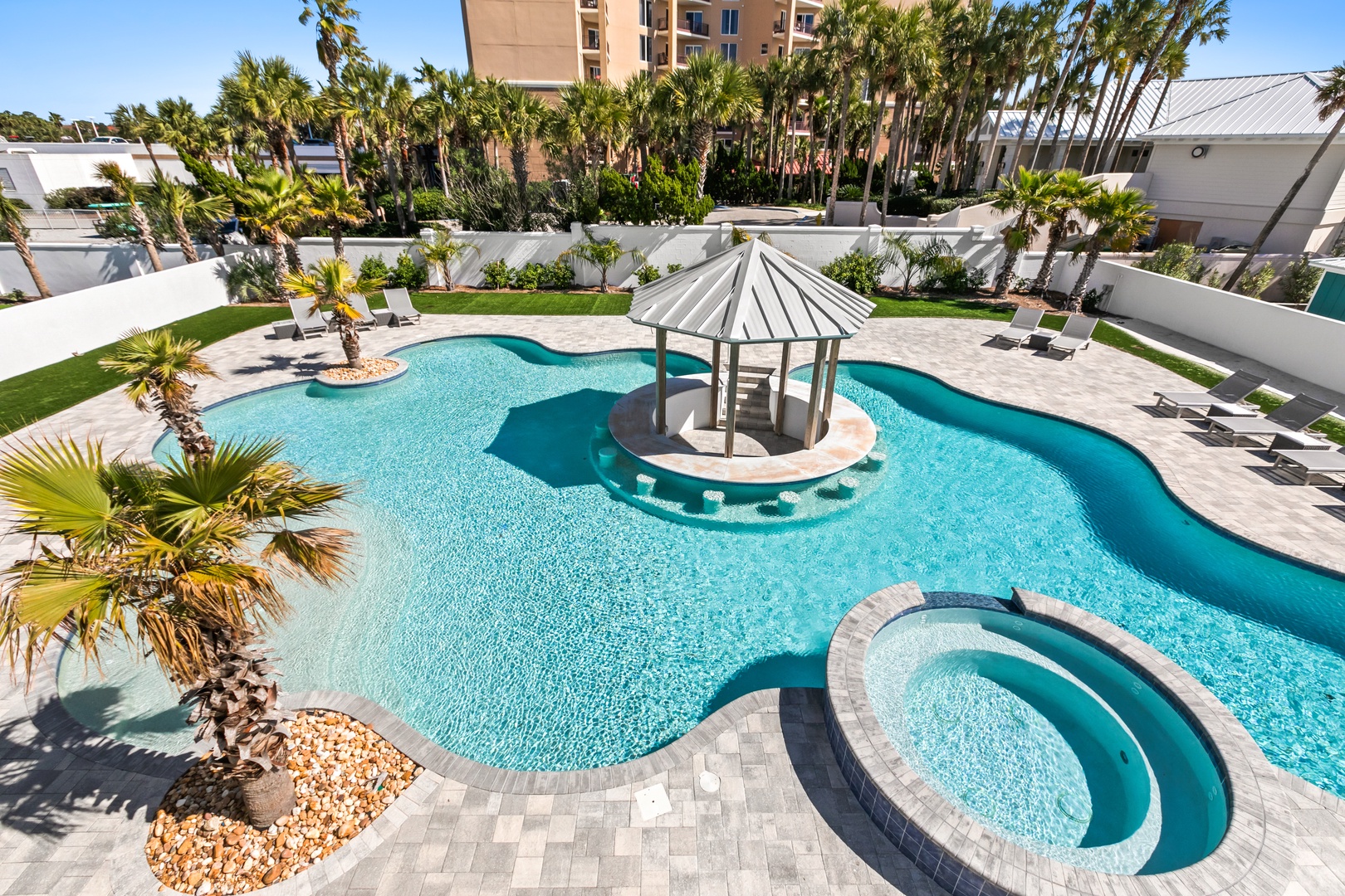 Your tropical oasis awaits, with a sparkling pool, swim-up bar gazebo, and jacuzzi surrounded by palm trees and lush lawns—perfect for sunny afternoons and pure relaxation.