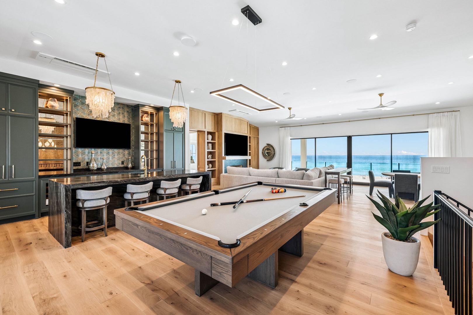Imagine relaxing with a game of pool while soaking in sweeping ocean views through floor-to-ceiling windows. Your gourmet kitchen, elegant bar seating, and plush lounge spaces flow together seamlessly—designed for unforgettable moments.