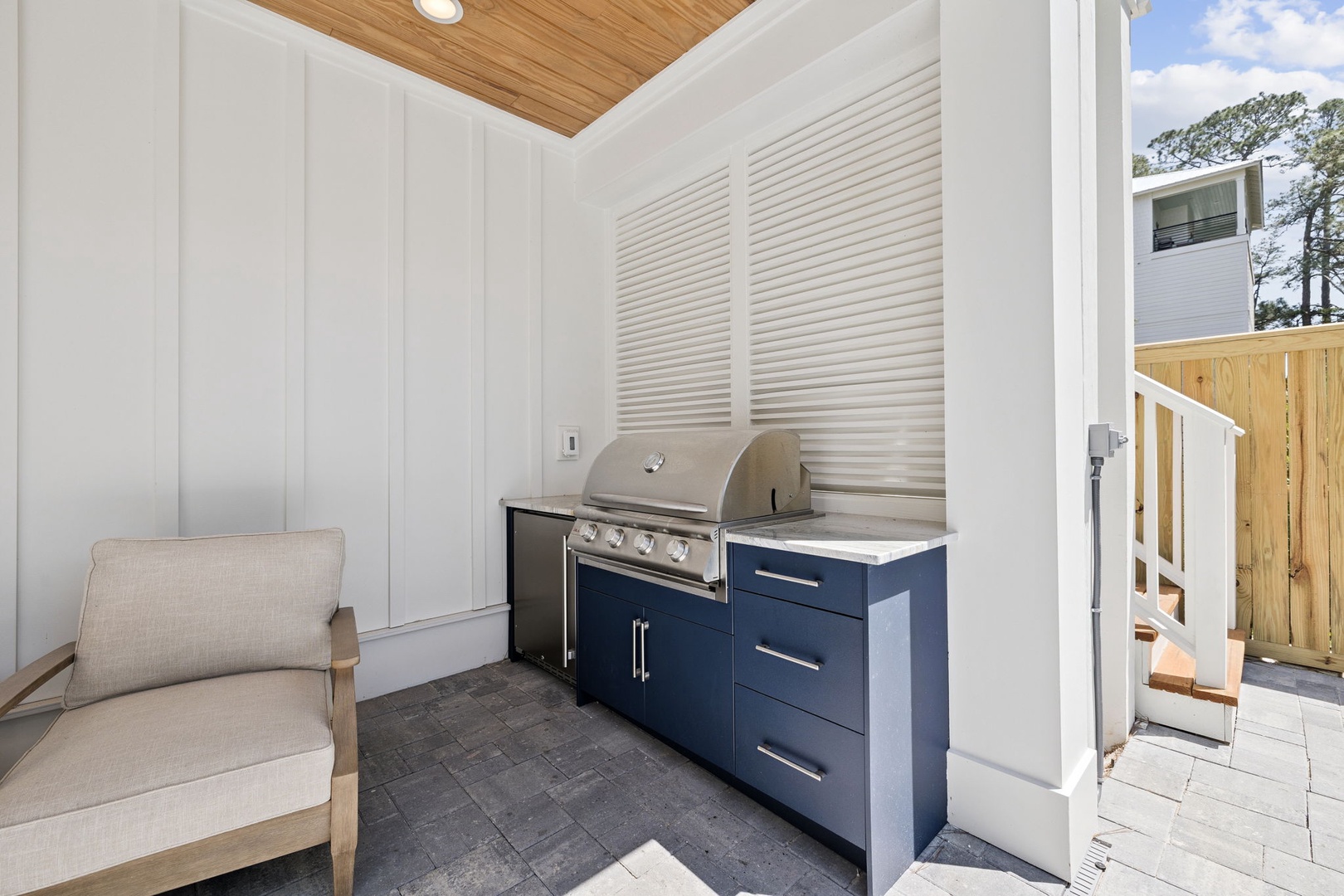 Your private outdoor kitchen awaits, complete with a built-in grill, storage, and a cozy spot to relax while you cook up memorable meals.