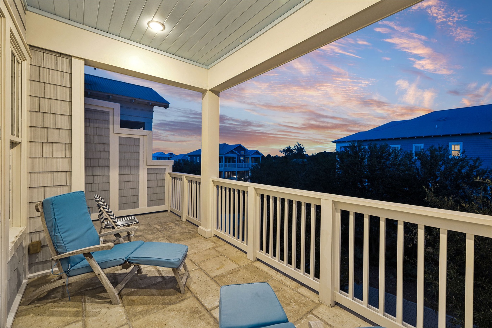 Unwind on your private balcony with coastal-inspired seating and soak in the vibrant sunset painting the sky—a peaceful retreat at the end of each day.