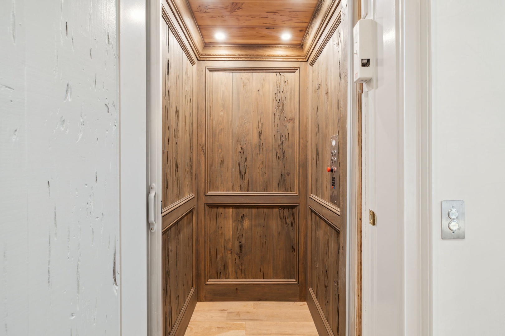 A spacious elevator with warm wood paneling and recessed lighting provides easy access throughout your stay, ensuring comfort and convenience at every level.