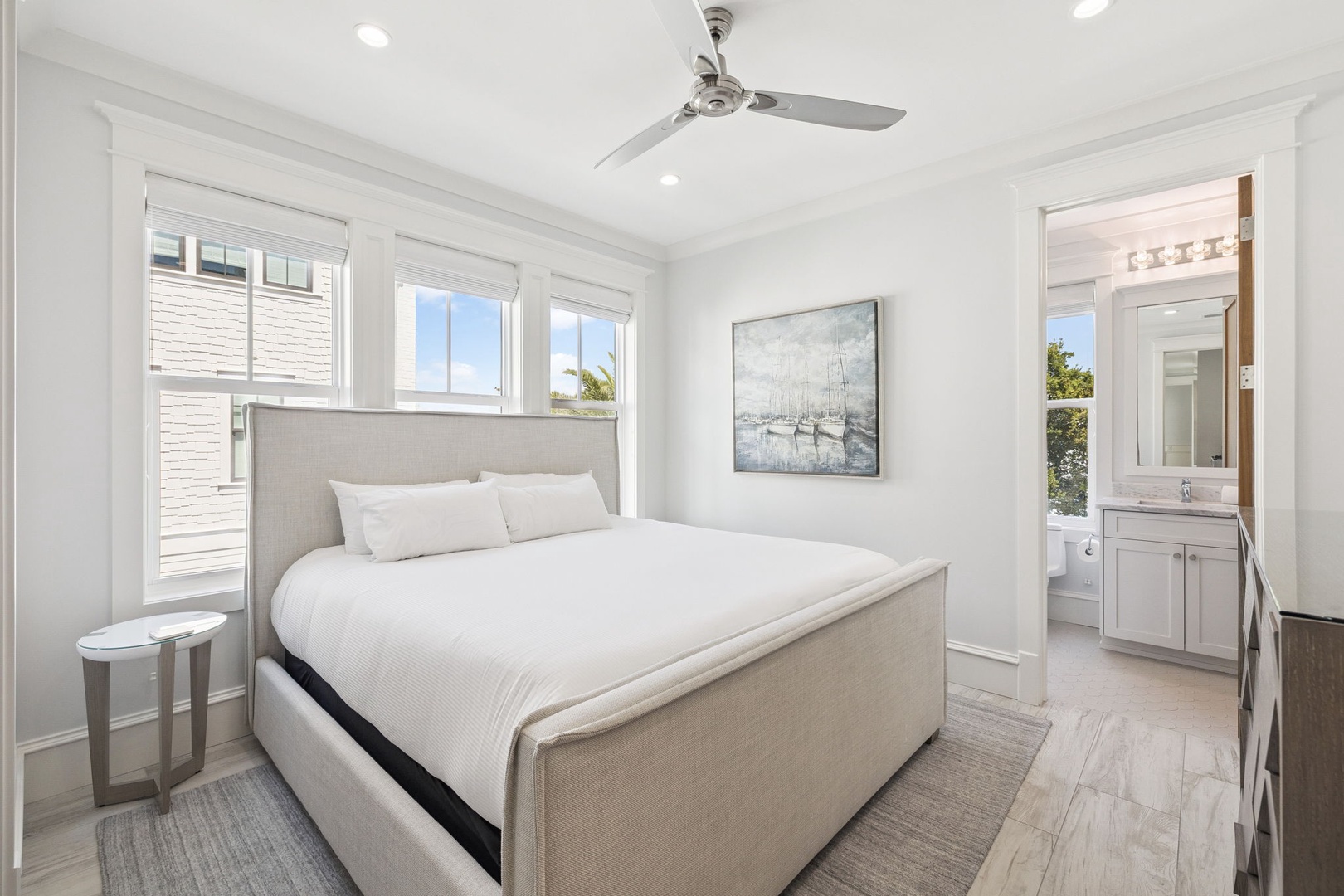 Your bright, airy bedroom features crisp linens, a ceiling fan for comfort, and an ensuite bathroom for convenience.