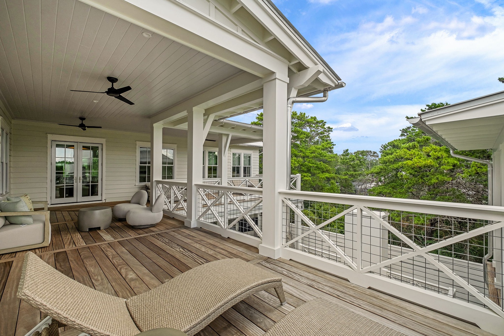 Relax on your private covered deck with comfortable lounge seating and serene treetop views—perfect for morning coffee or unwinding after a day of exploring the surrounding natural beauty.