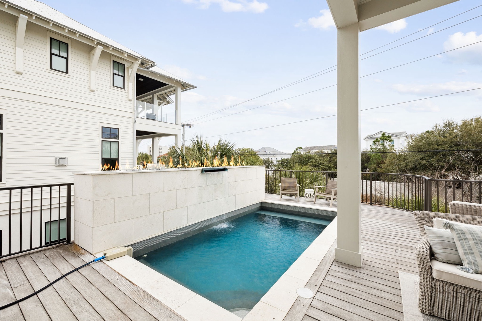 Relax by your private pool surrounded by comfortable lounge chairs and tropical palms on this peaceful deck.