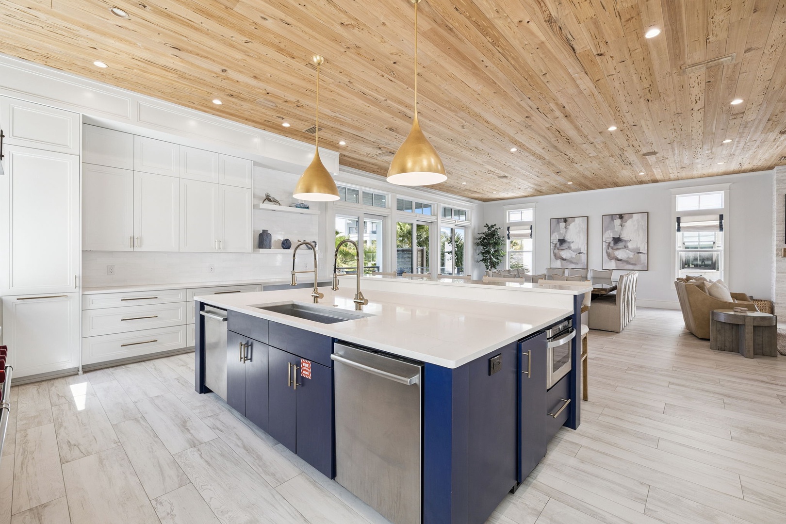 Gather around this stunning open kitchen with gleaming countertops, modern appliances, and soaring wood ceilings that create your perfect culinary haven.