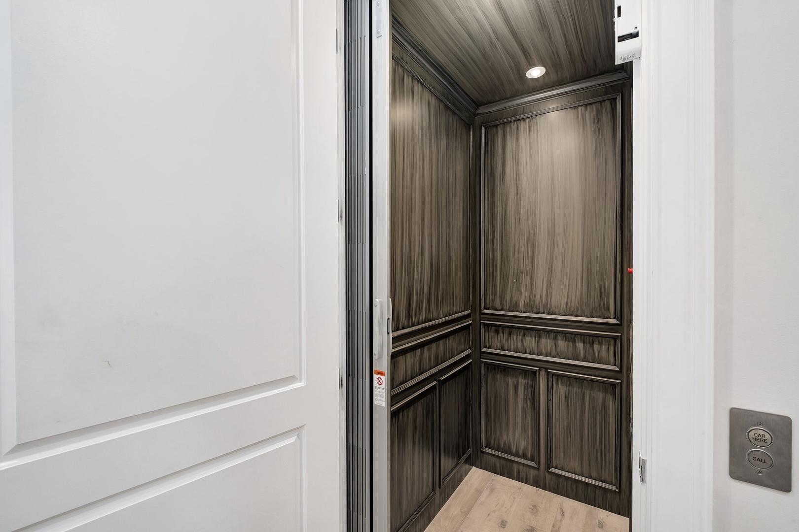 Step into your private elevator with elegant wood paneling and modern controls for effortless access to your retreat.