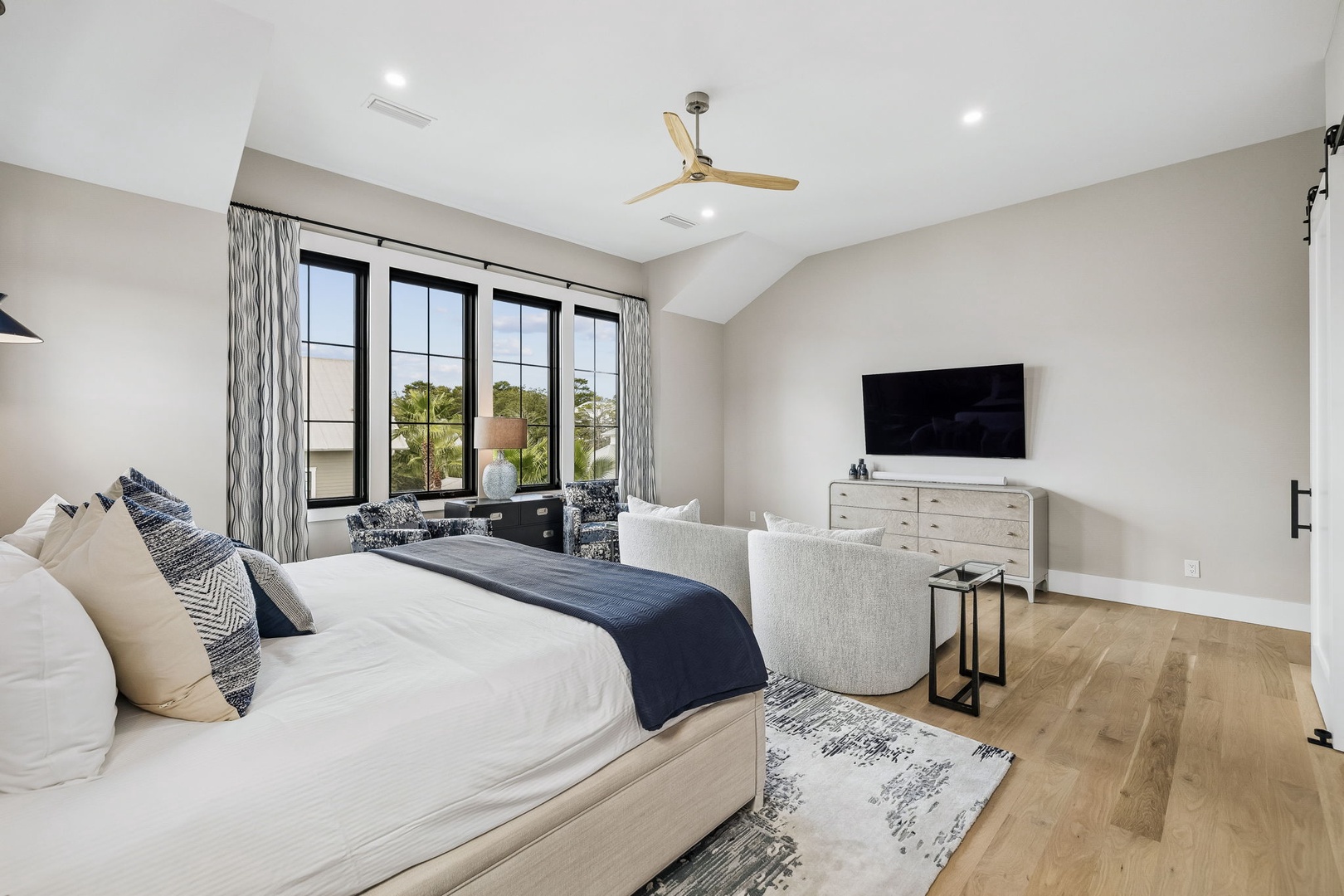 Drift off in your spacious bedroom with soaring vaulted ceilings and natural light streaming through large windows. Curl up in the cozy seating nook with your morning coffee and soak in serene treetop views.