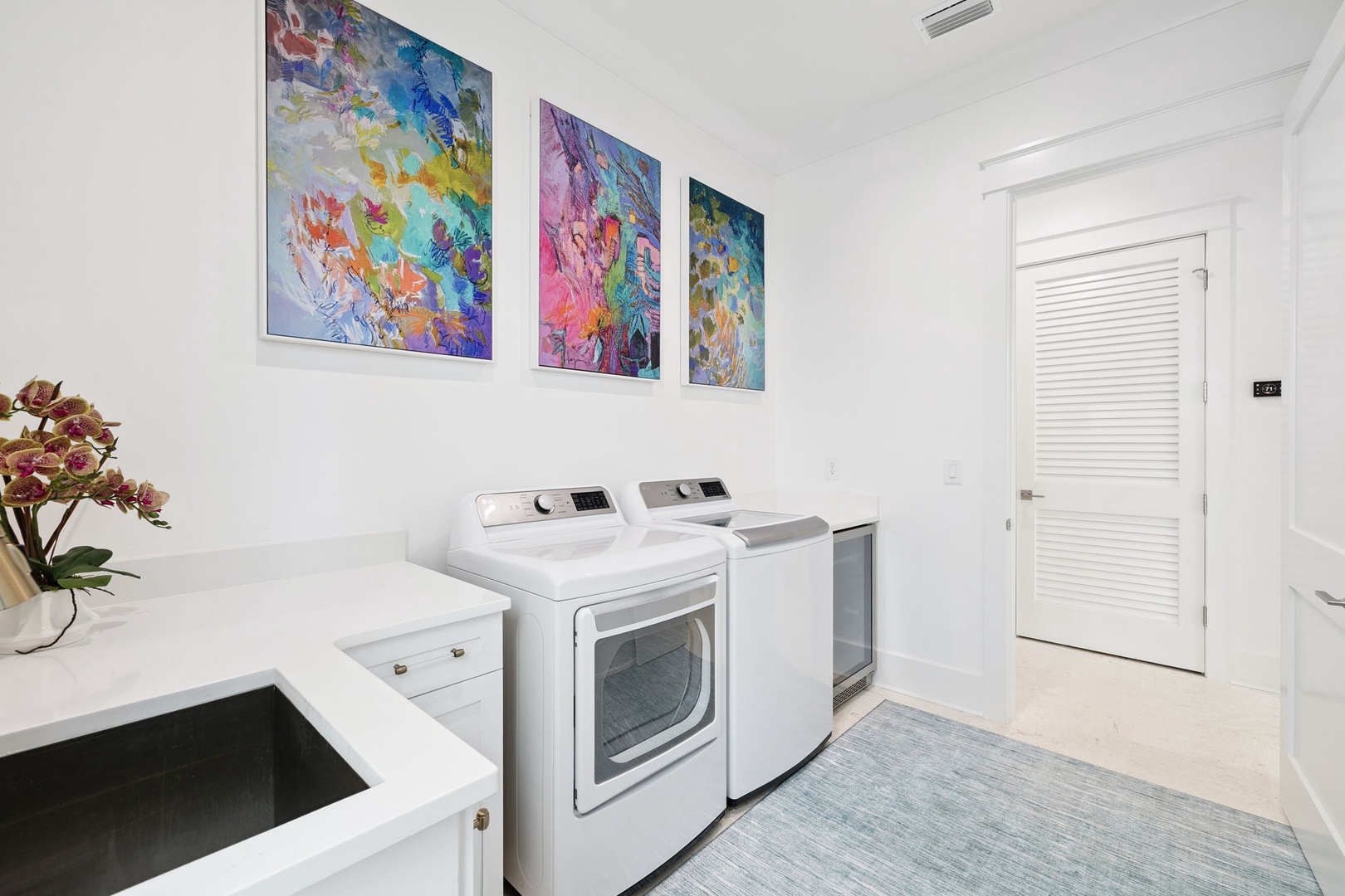 Your bright laundry room features full-size appliances and cheerful artwork, making chores feel effortless during your stay.