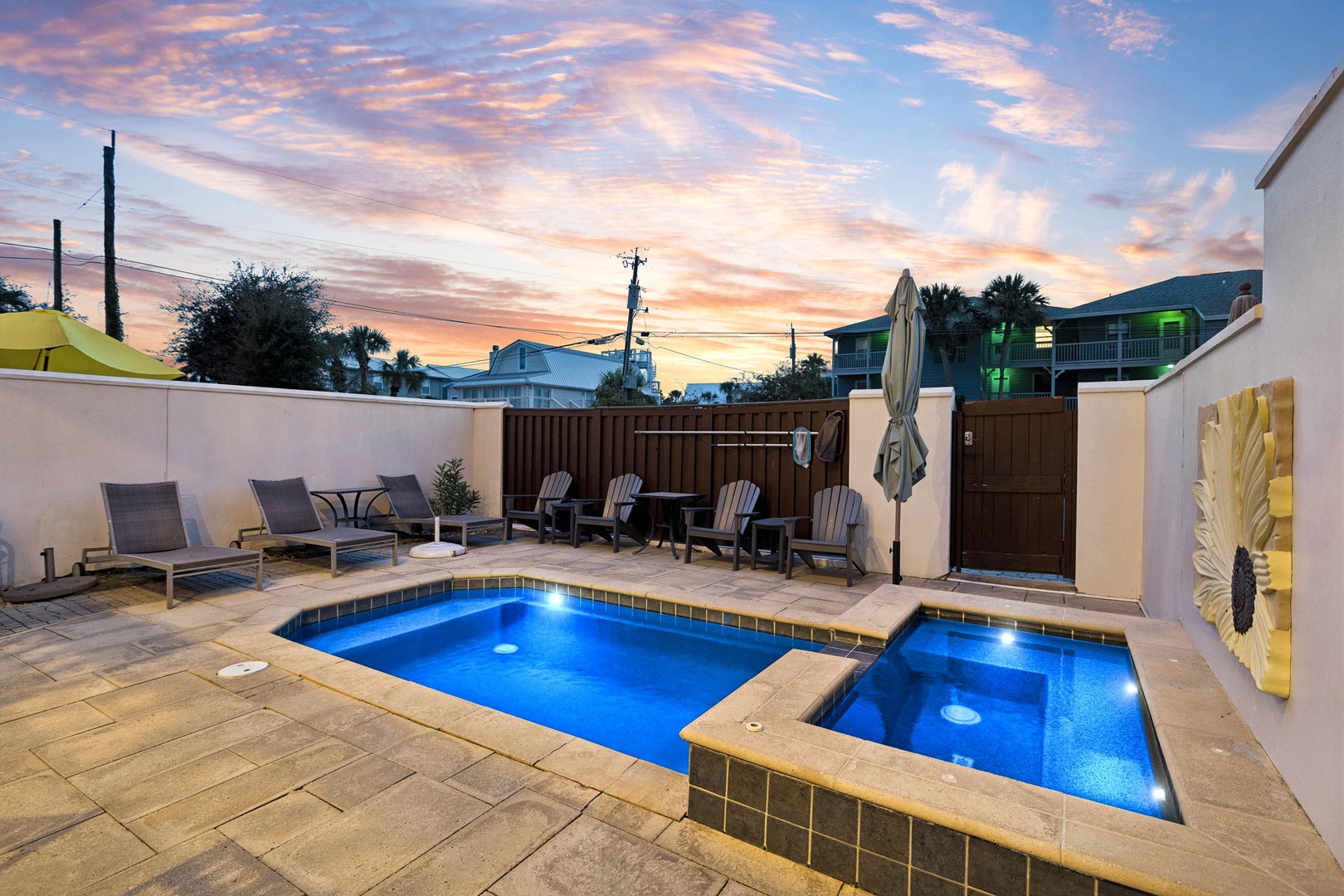 Your private oasis awaits at twilight, where a sparkling pool and adjacent hot tub invite you to soak under painted skies. Lounge on deck chairs or gather with friends around the patio, all while sunset hues dance overhead.
