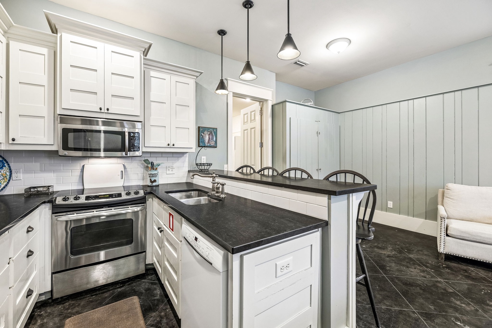 Your fully equipped kitchen features sleek countertops, stainless appliances, and a central island perfect for meal prep or casual dining together.