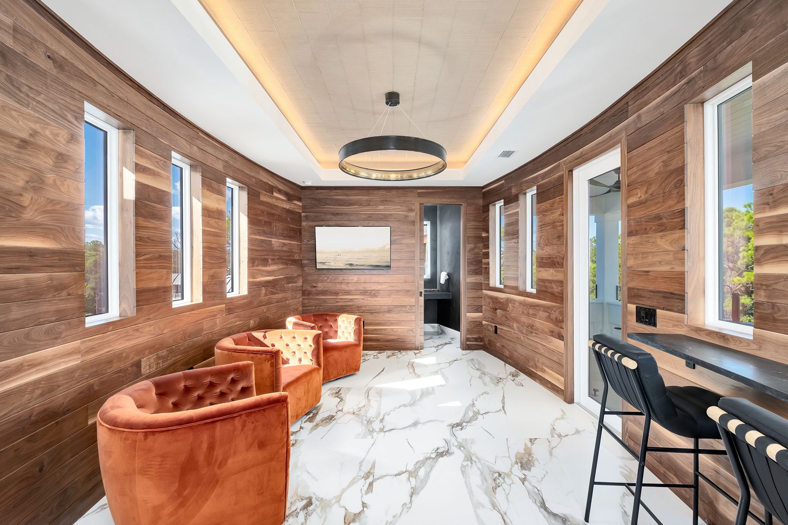 Sink into plush velvet seating beneath warm wood and ambient lighting, your perfect retreat for unwinding after exploring the area.