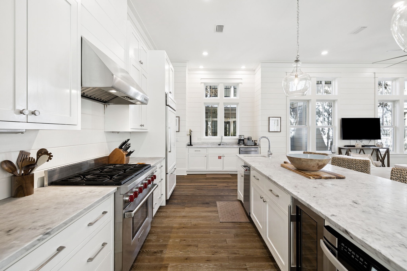 Your gourmet kitchen awaits with marble countertops, professional gas range, and an open flow to the living area—perfect for cooking memorable meals together.