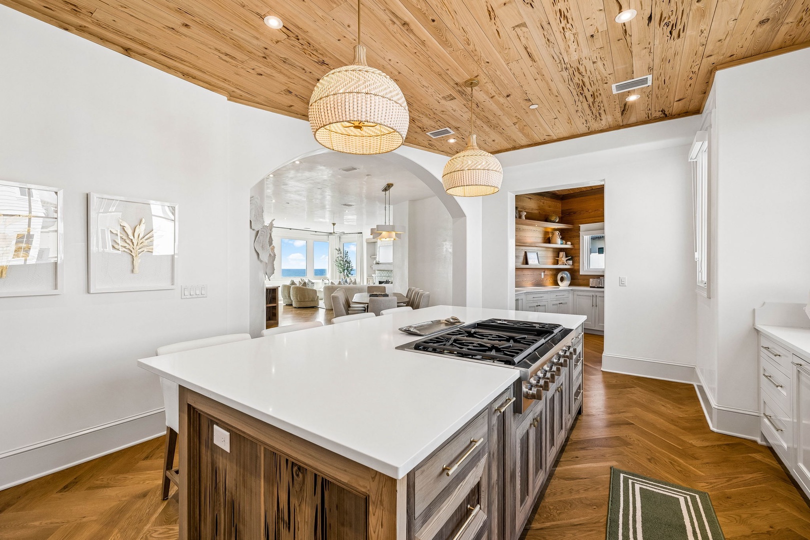 Your gourmet kitchen features a spacious island with a gas cooktop, perfect for preparing fresh meals while natural light flows through the home.