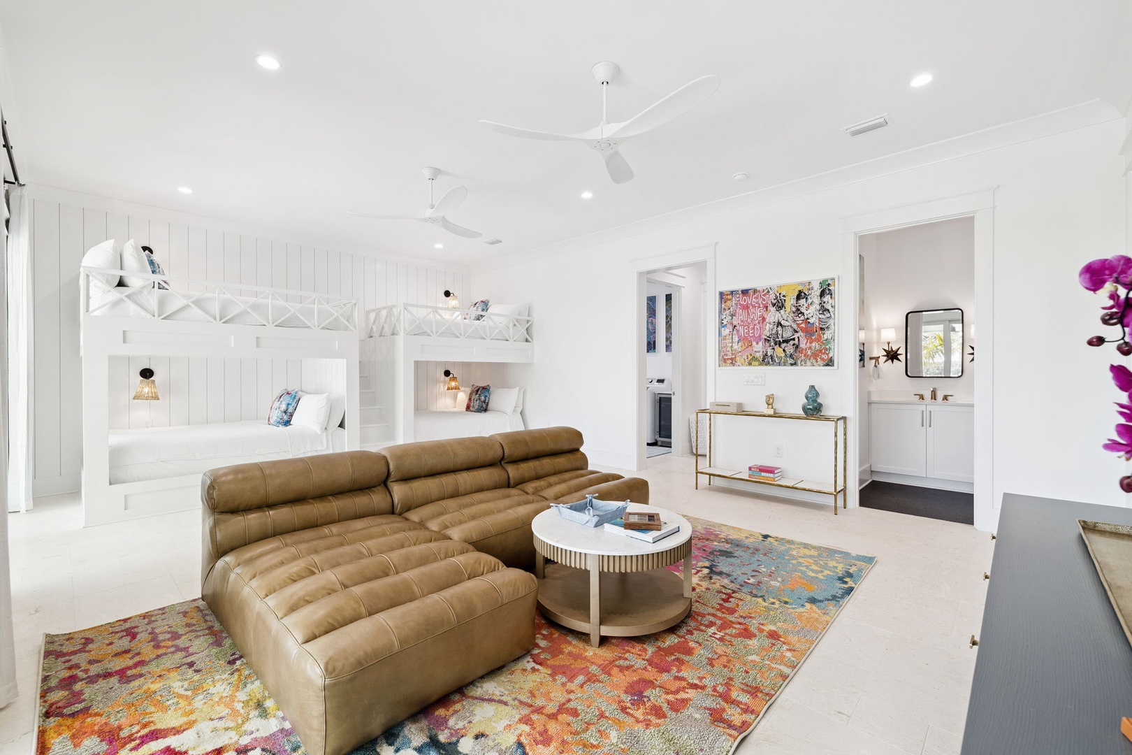 Your stylish retreat features plush leather seating, colorful art, and charming bunk beds - perfect for family gatherings.