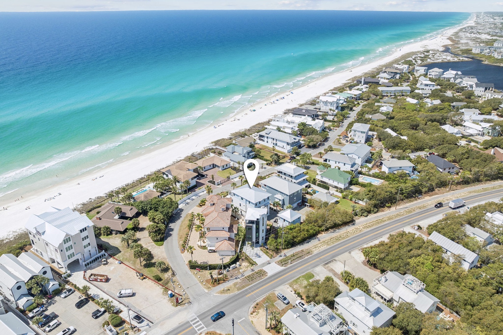 Coastal retreat positioned perfectly between pristine white sand beaches and turquoise waters, nestled in a charming beachfront neighborhood.