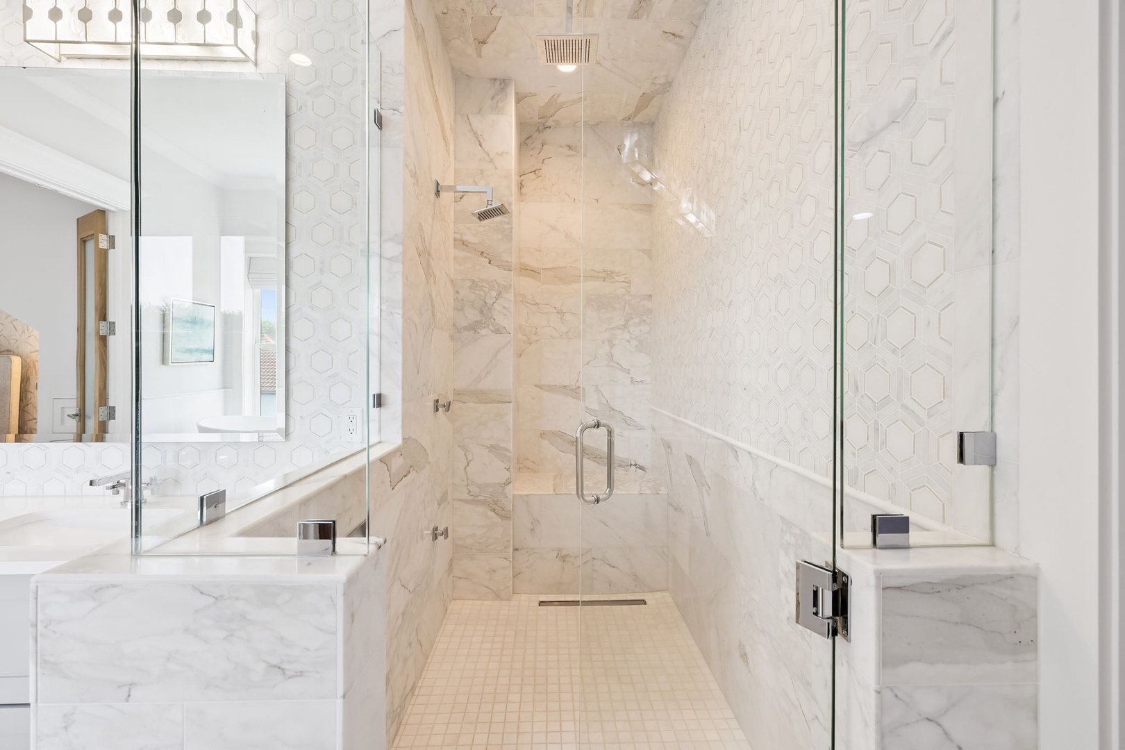 Step into your luxurious marble sanctuary with a stunning walk-in shower featuring rainfall showerhead and elegant glass enclosure.