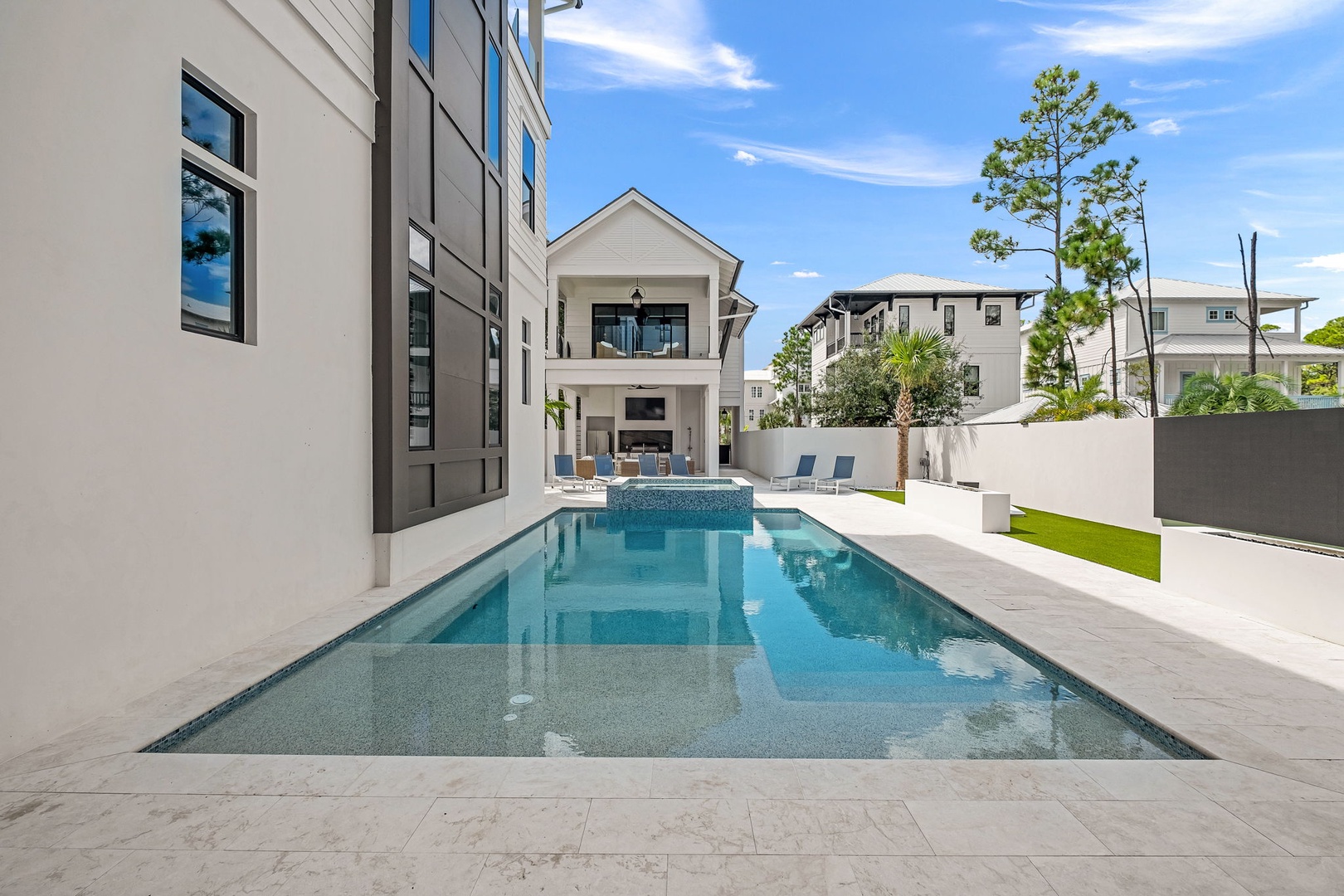 Step outside to your private backyard oasis—a stunning pool surrounded by modern design and plenty of space to soak up the Florida sun.
