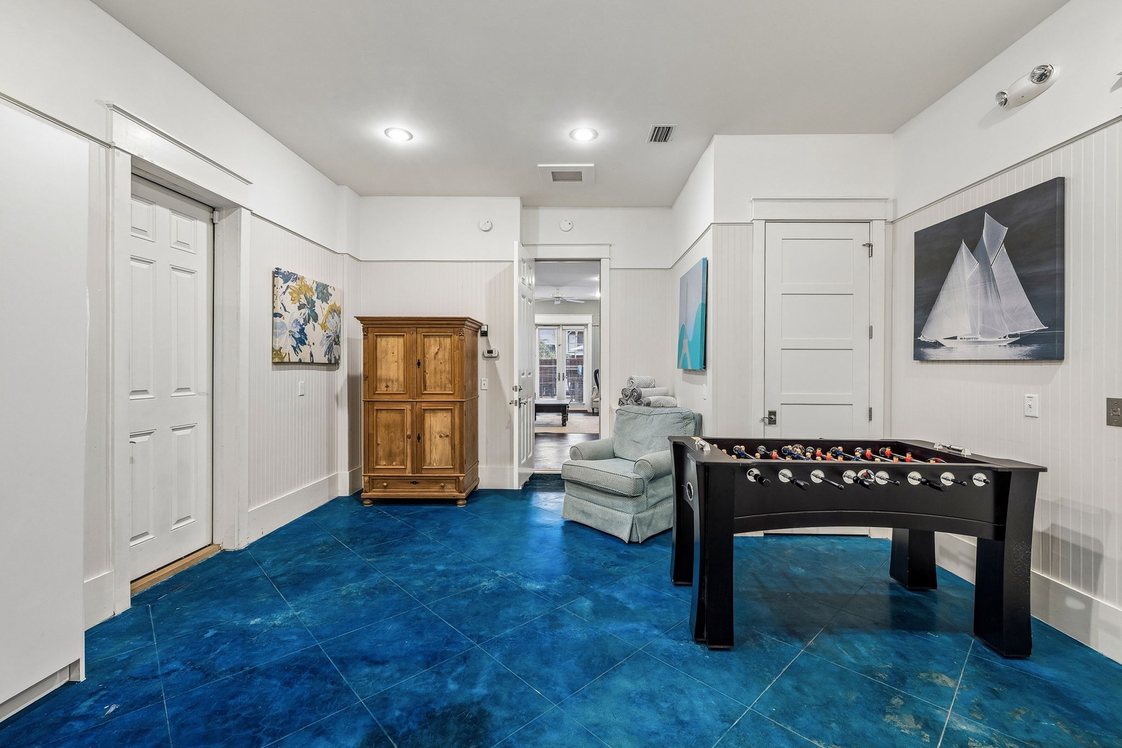 Your private game room features a sleek foosball table on stunning turquoise tile flooring—the perfect spot for friendly competition and relaxation after a day of exploring.