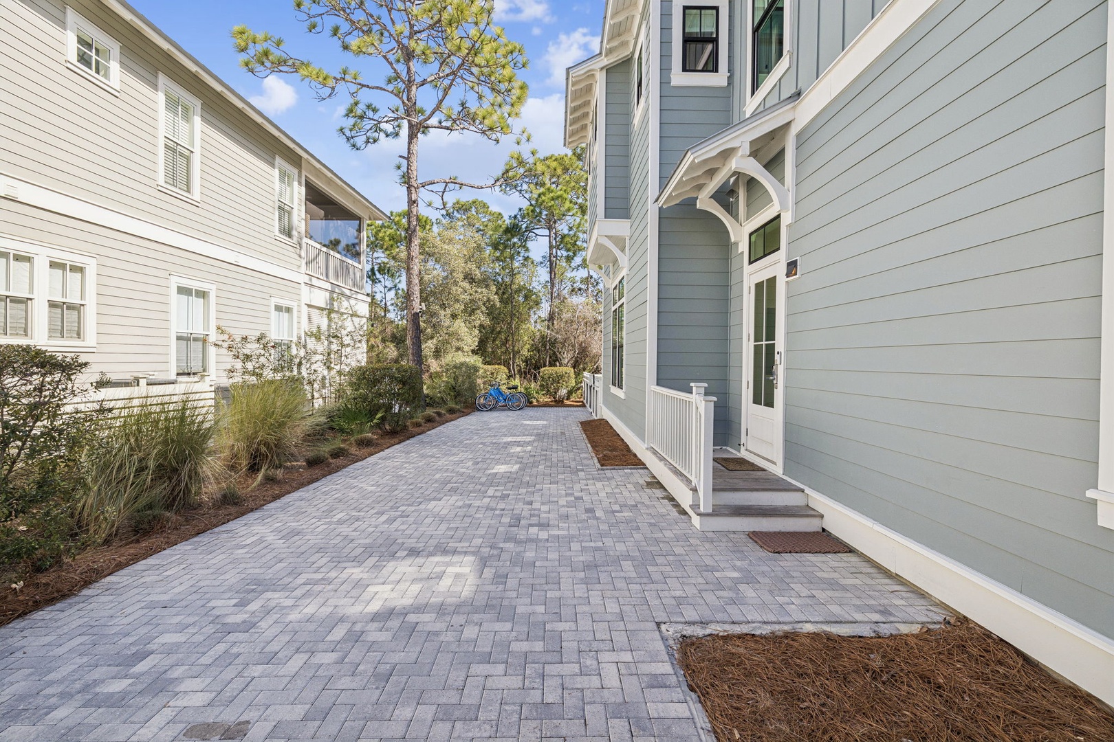 A charming residential area with well-maintained coastal architecture and mature trees creates a peaceful neighborhood setting.