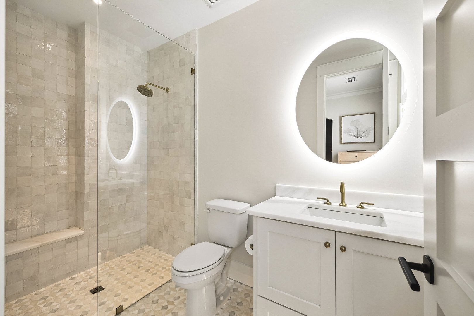 Step into your beautifully designed bathroom with a spacious walk-in shower and elegant tilework. The backlit mirror and modern vanity create a spa-like atmosphere where you can unwind.