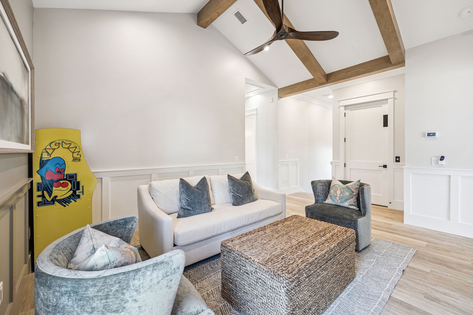 Unwind in your sophisticated living room featuring exposed wooden beams, plush seating, and thoughtful coastal touches that create the perfect retreat.