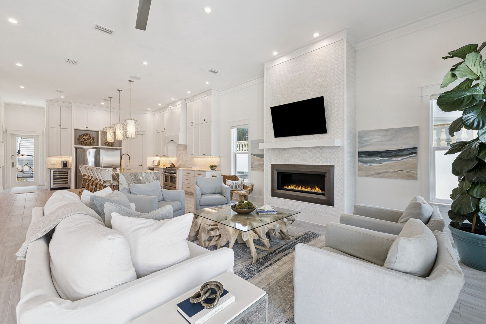Unwind in this stunning open-concept living space with plush seating, a cozy fireplace, and seamless flow to the gourmet kitchen.