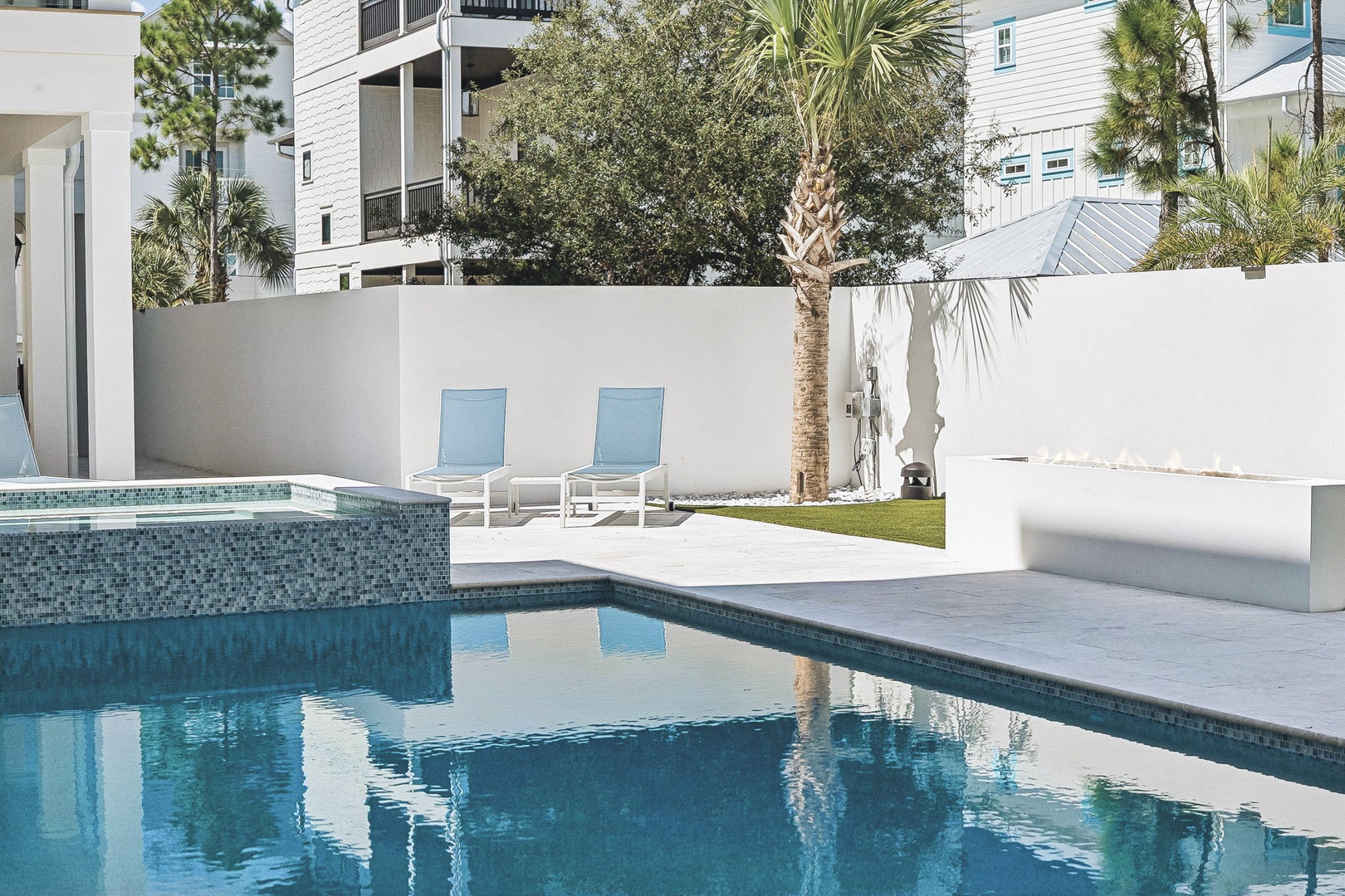 Your private oasis awaits—cool off in the sparkling pool, lounge on the deck under swaying palms, and enjoy complete relaxation behind privacy walls in your own secluded backyard.