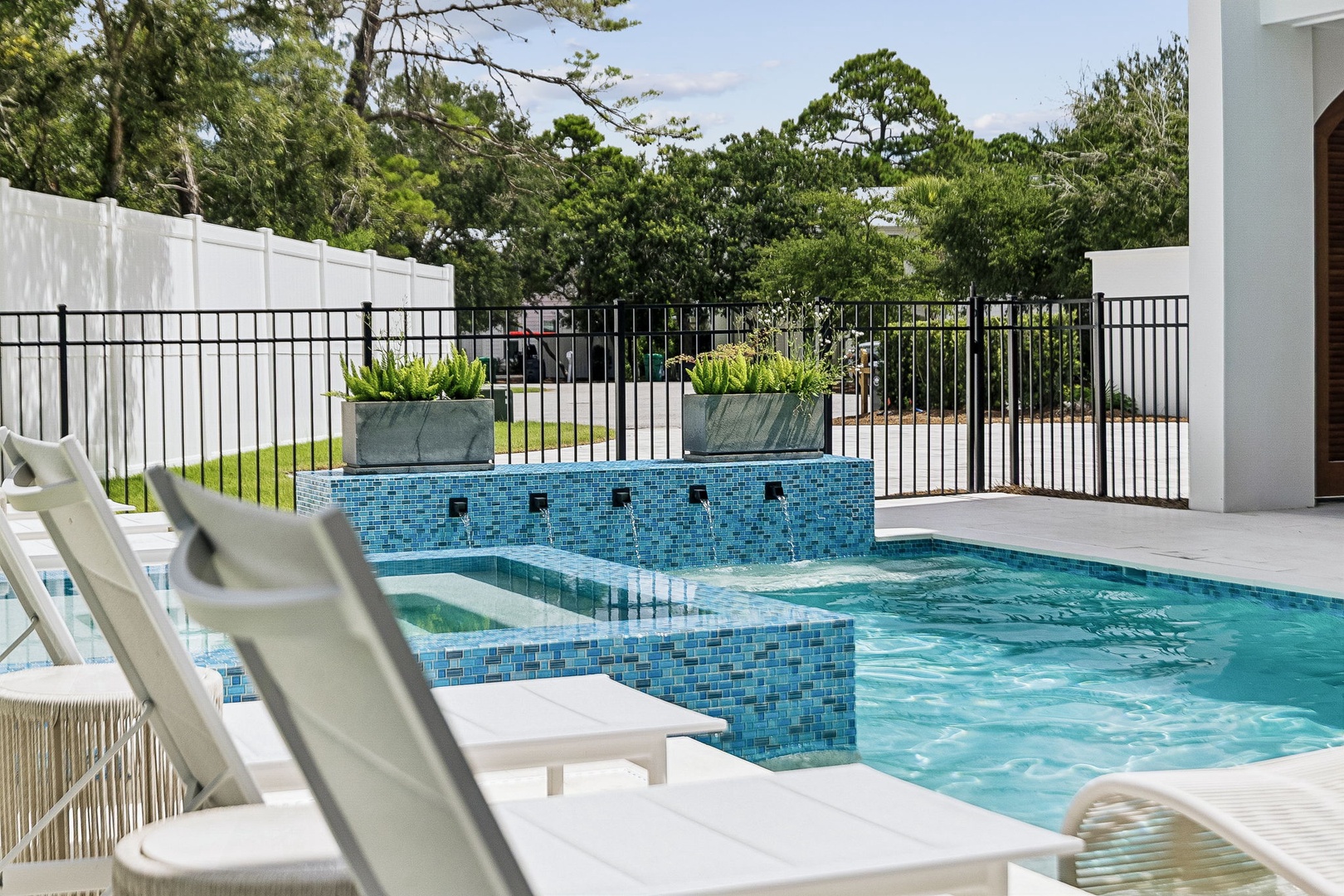 Relax by your private pool, where sleek loungers and soothing water features create the perfect escape. The sparkling mosaic tiles and lush surroundings invite you to unwind in style.