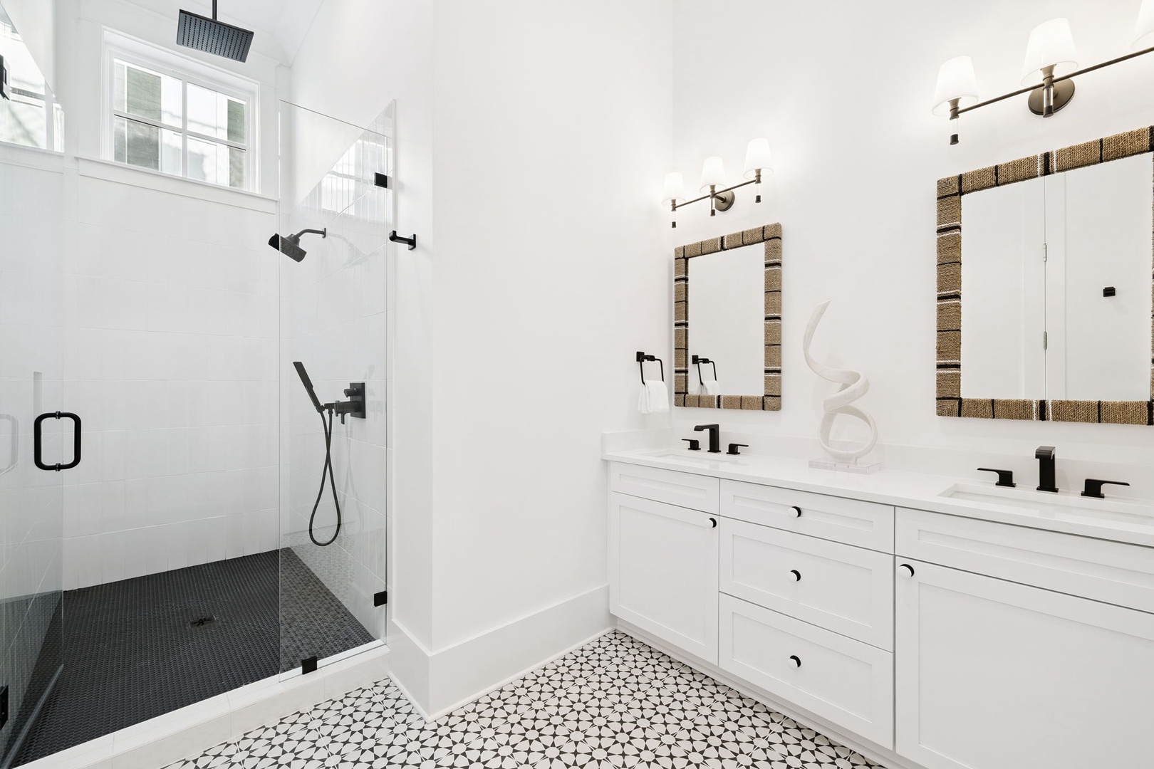 Indulge in your private spa-like bathroom featuring a spacious walk-in shower, elegant dual vanity, and beautiful patterned floors.