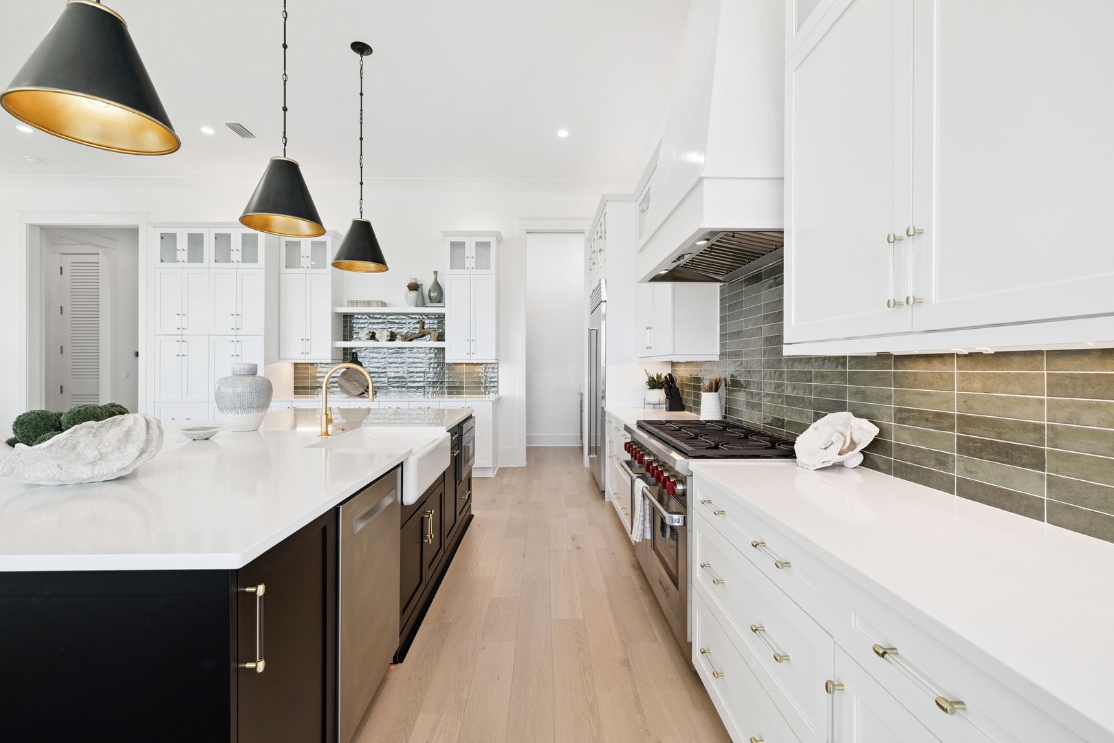 Your spacious gourmet kitchen invites culinary adventures with marble countertops, professional appliances, and elegant pendant lighting creating the perfect cooking atmosphere.