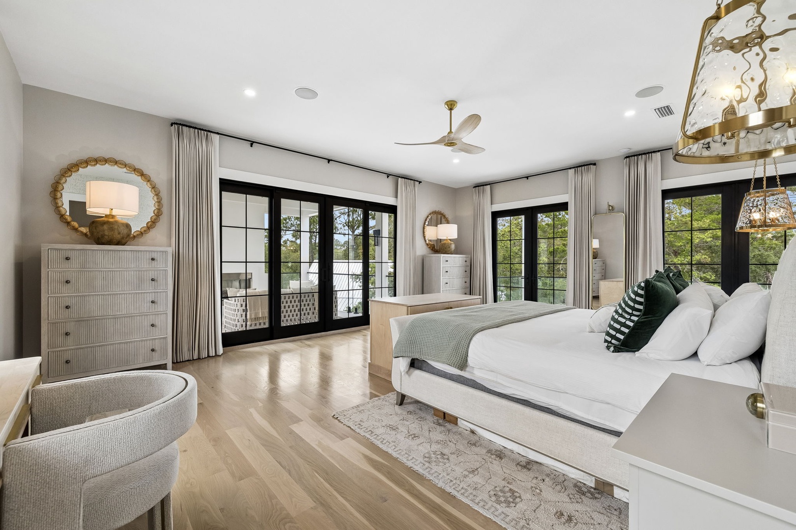 Sink into crisp linens and wake to natural light streaming through French doors that open to your private balcony, framing serene views of lush greenery.