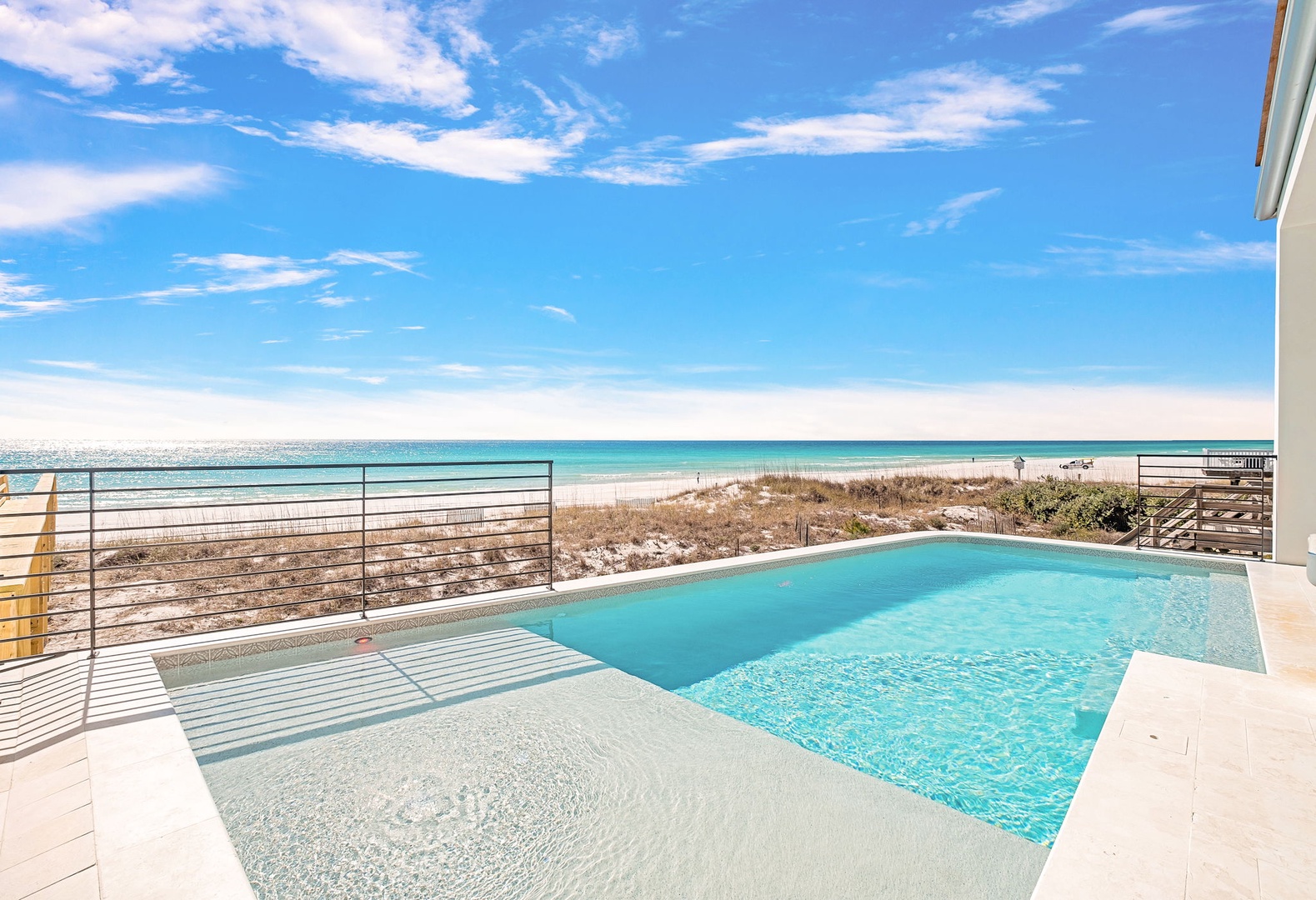 Your private pool overlooks pristine white sand and crystal-clear waters, creating the perfect beachfront escape.