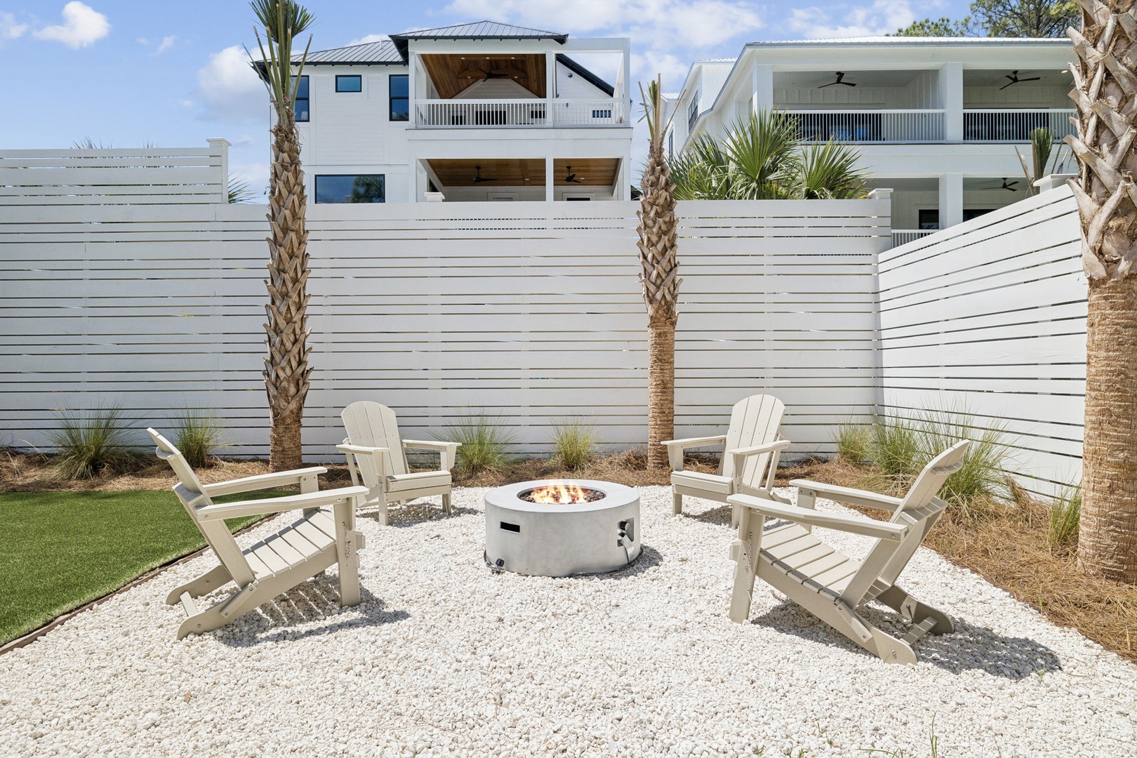 Gather around your private fire pit surrounded by comfortable Adirondack chairs, where evenings become magical under swaying palms.