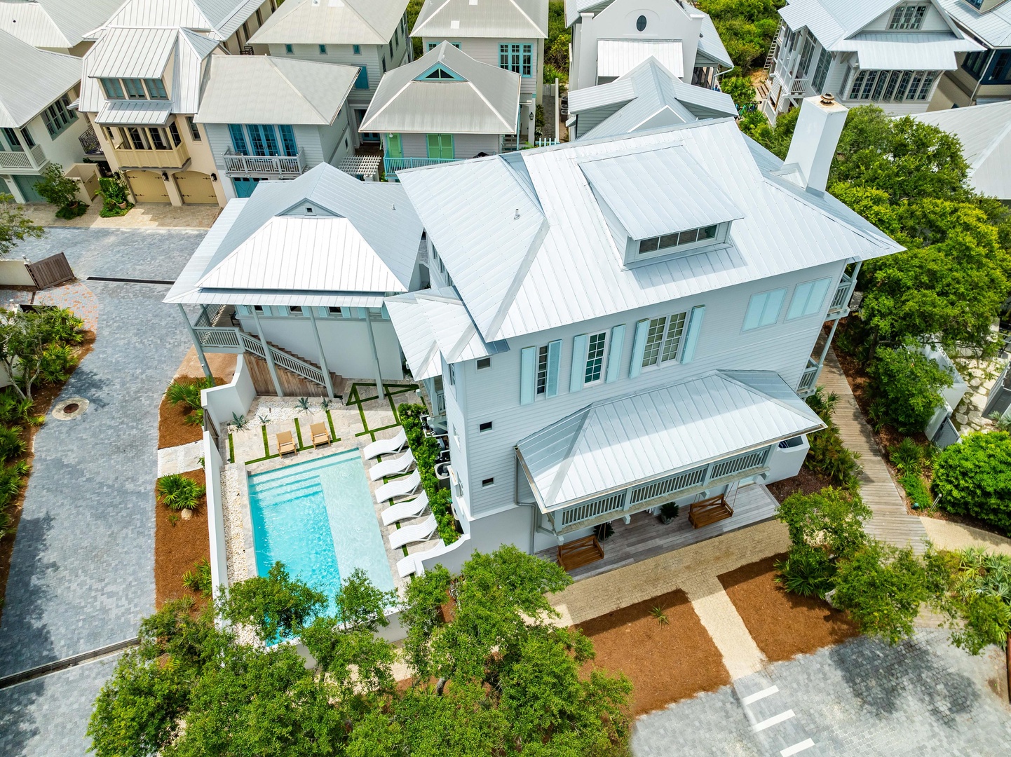 Stunning coastal vacation home with private pool and elegant white architecture nestled in a charming beachside neighborhood.