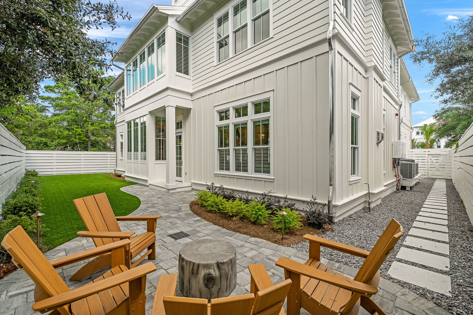A peaceful backyard retreat with landscaped gardens and a charming exterior setting framed by lush greenery.
