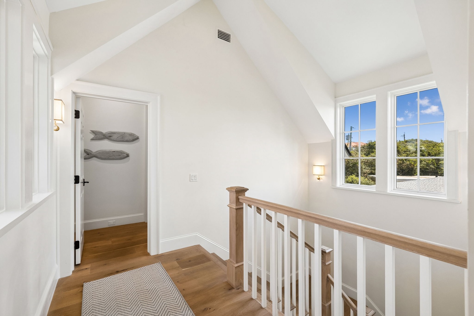 Bright, airy landing with vaulted ceilings and natural light streaming through the windows. A peaceful transitional space connecting your upstairs retreat to the rest of the home.