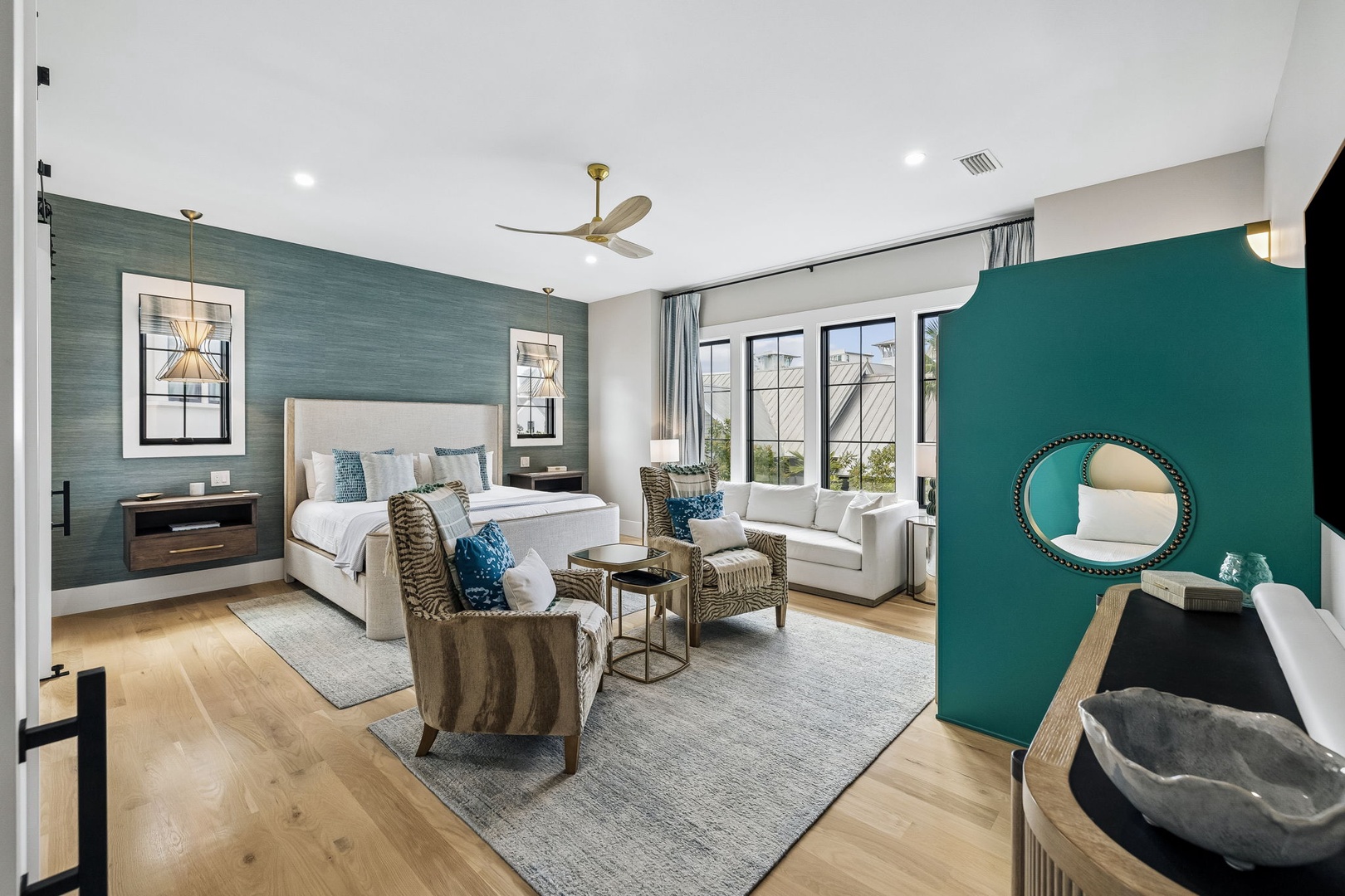 Sink into your plush king bed, unwind in cozy accent chairs, and let the natural light from oversized windows fill your thoughtfully styled retreat with warmth and calm.