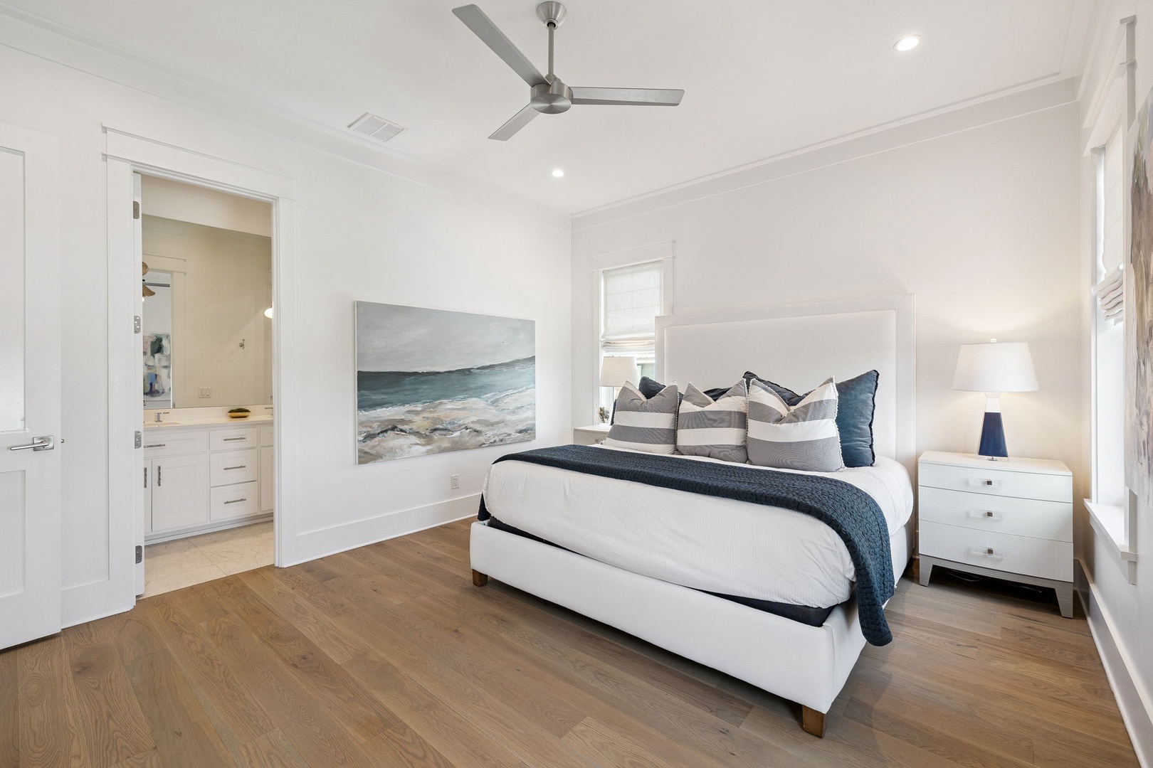 Drift off to peaceful sleep in your coastal-inspired bedroom with ocean artwork and modern comfort.