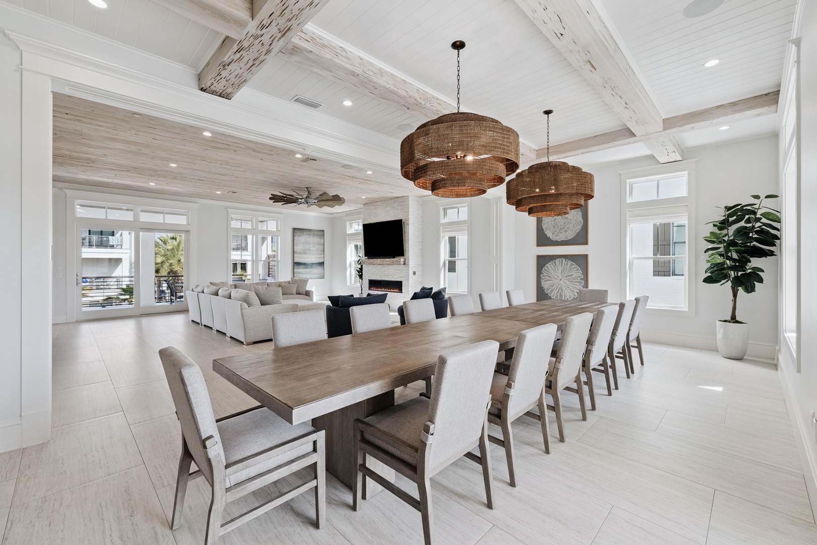 Gather your group around this stunning dining table under elegant pendant lights, with the cozy living area perfect for post-meal relaxation.