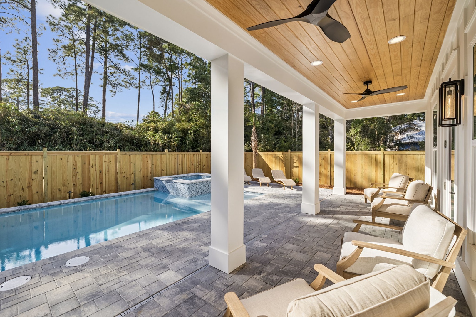 Unwind on your private covered patio with luxurious lounge chairs overlooking the sparkling pool and serene spa.