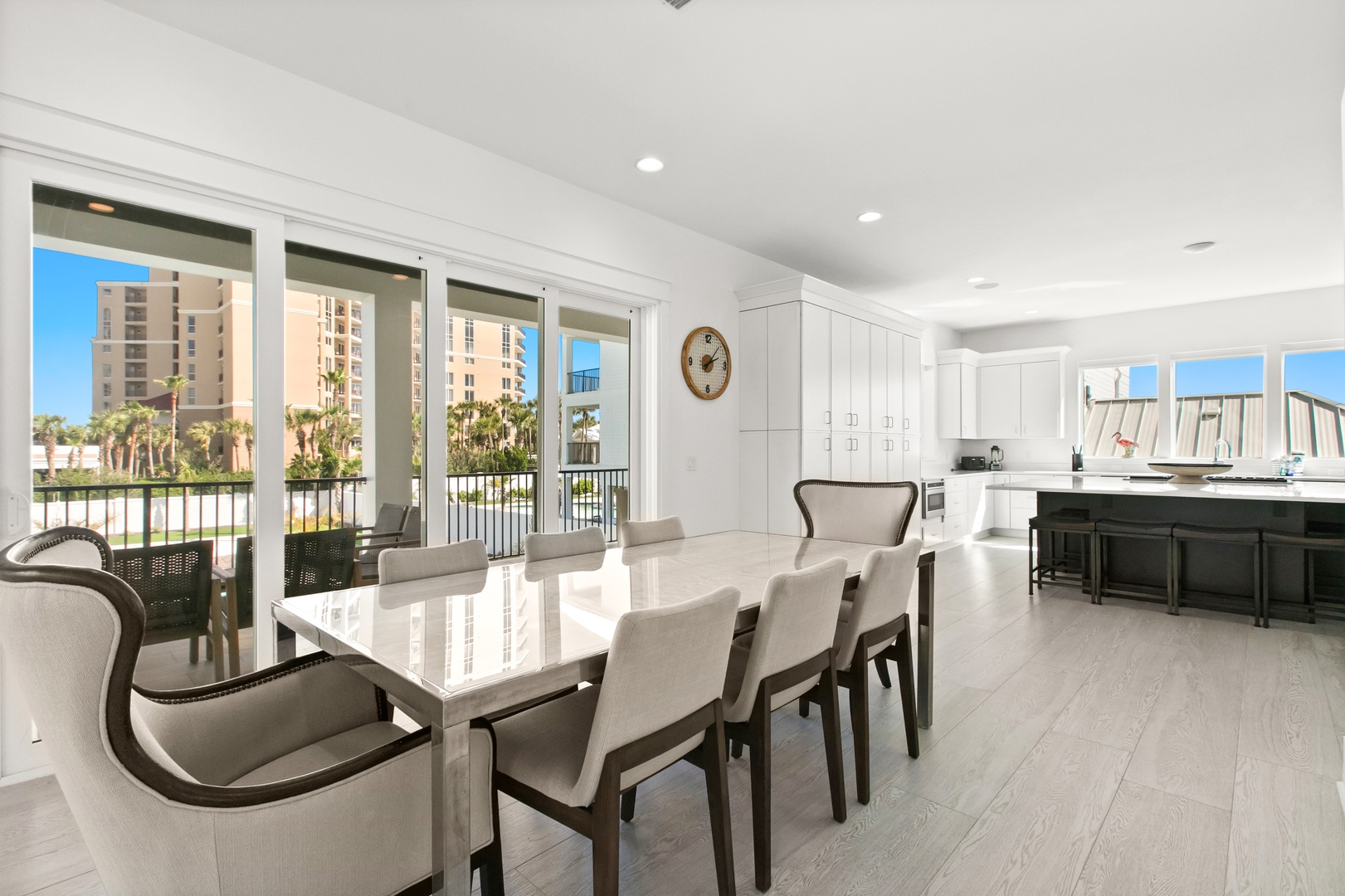 Step into your sun-drenched open-concept space where a stylish dining area flows seamlessly into a sleek kitchen. Floor-to-ceiling windows invite coastal breezes and frame your balcony, perfect for morning coffee or evening wind-downs.