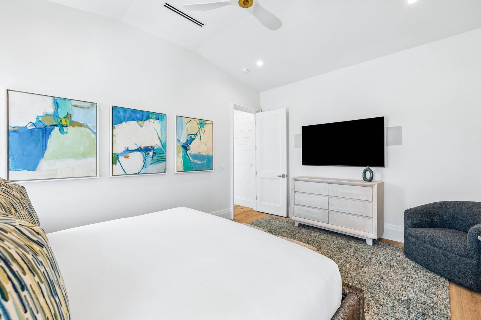 Unwind in your bright, modern bedroom with a plush queen bed and contemporary artwork adorning the walls. Enjoy your favorite shows on the flat-screen TV after a day of adventure.