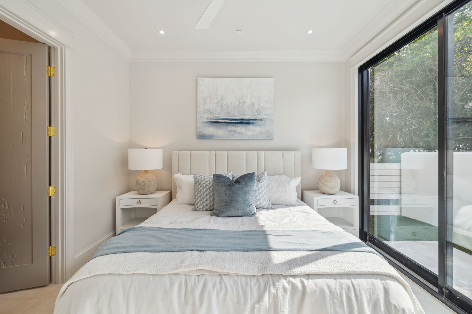 Wake up to soft natural light and serene garden views through your floor-to-ceiling glass doors, with luxurious linens inviting peaceful mornings and restful nights.