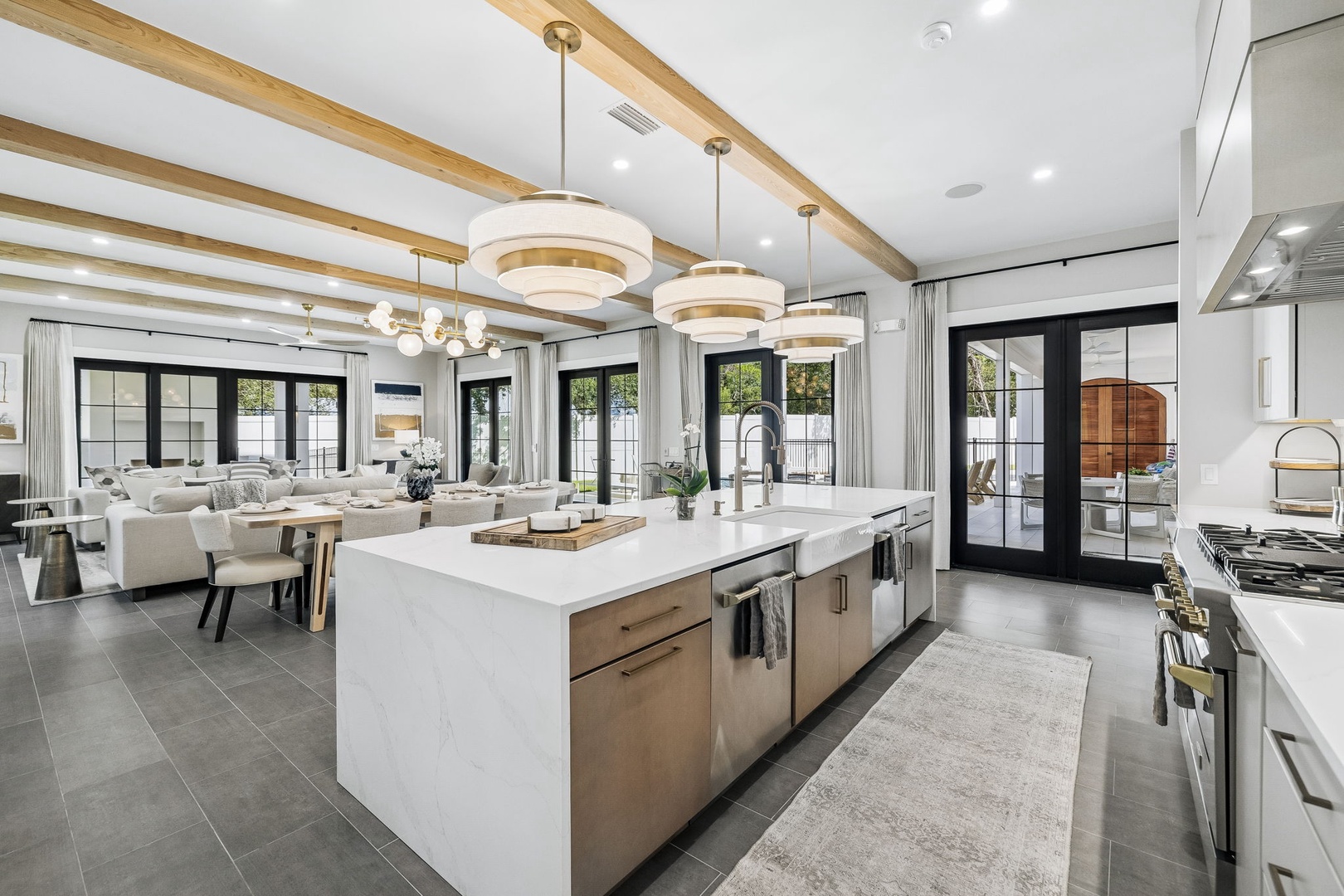 Stunning open-concept living with gourmet kitchen and floor-to-ceiling doors opening to a private patio—the perfect backdrop for your dream vacation.