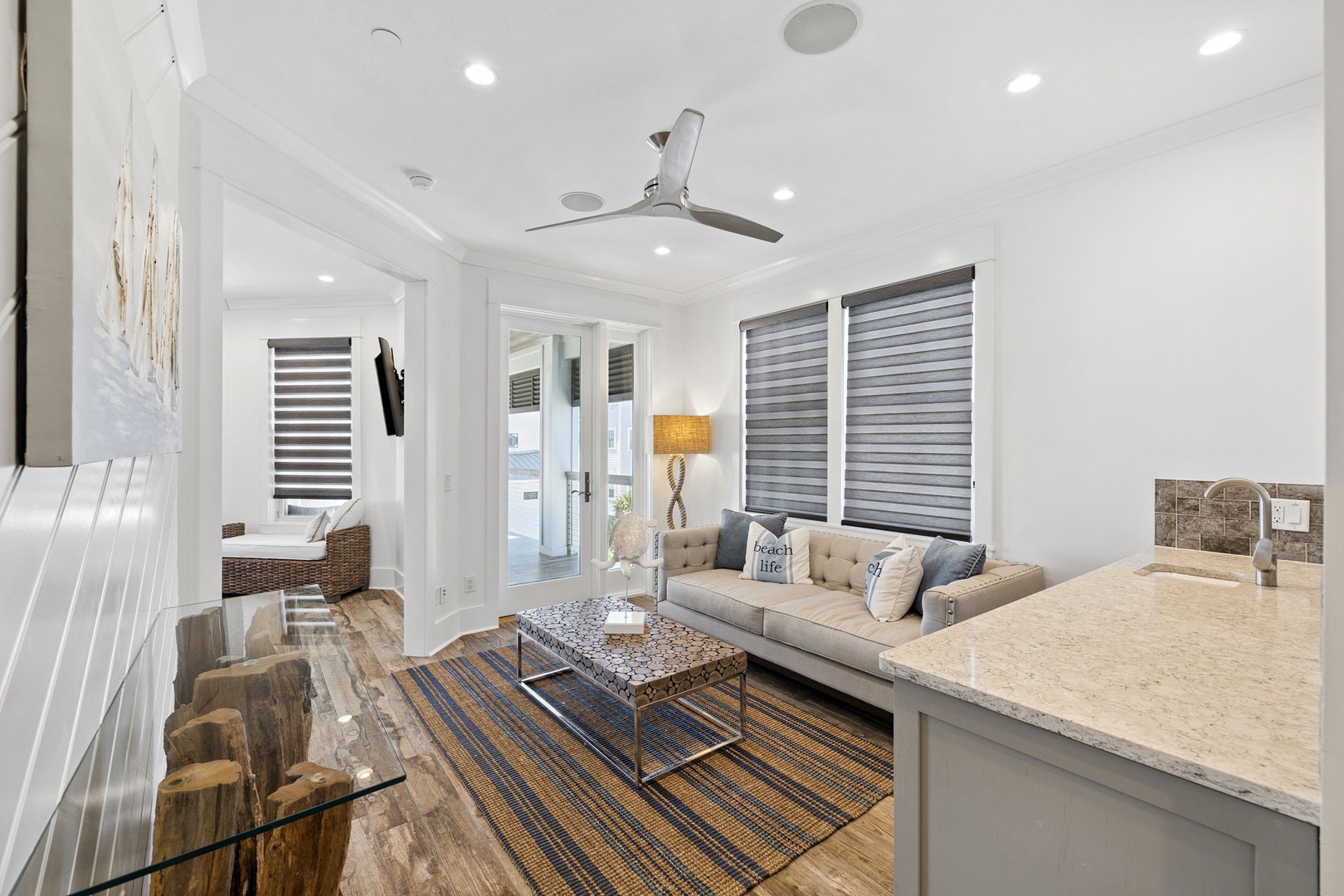 Relax in your bright, modern living space with comfortable seating and stylish coastal touches.